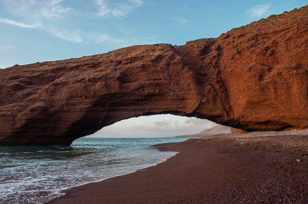 Breathtaking view of the iconic natural arch at Legzira Beach in Morocco, perfect for travel and nature scenes.