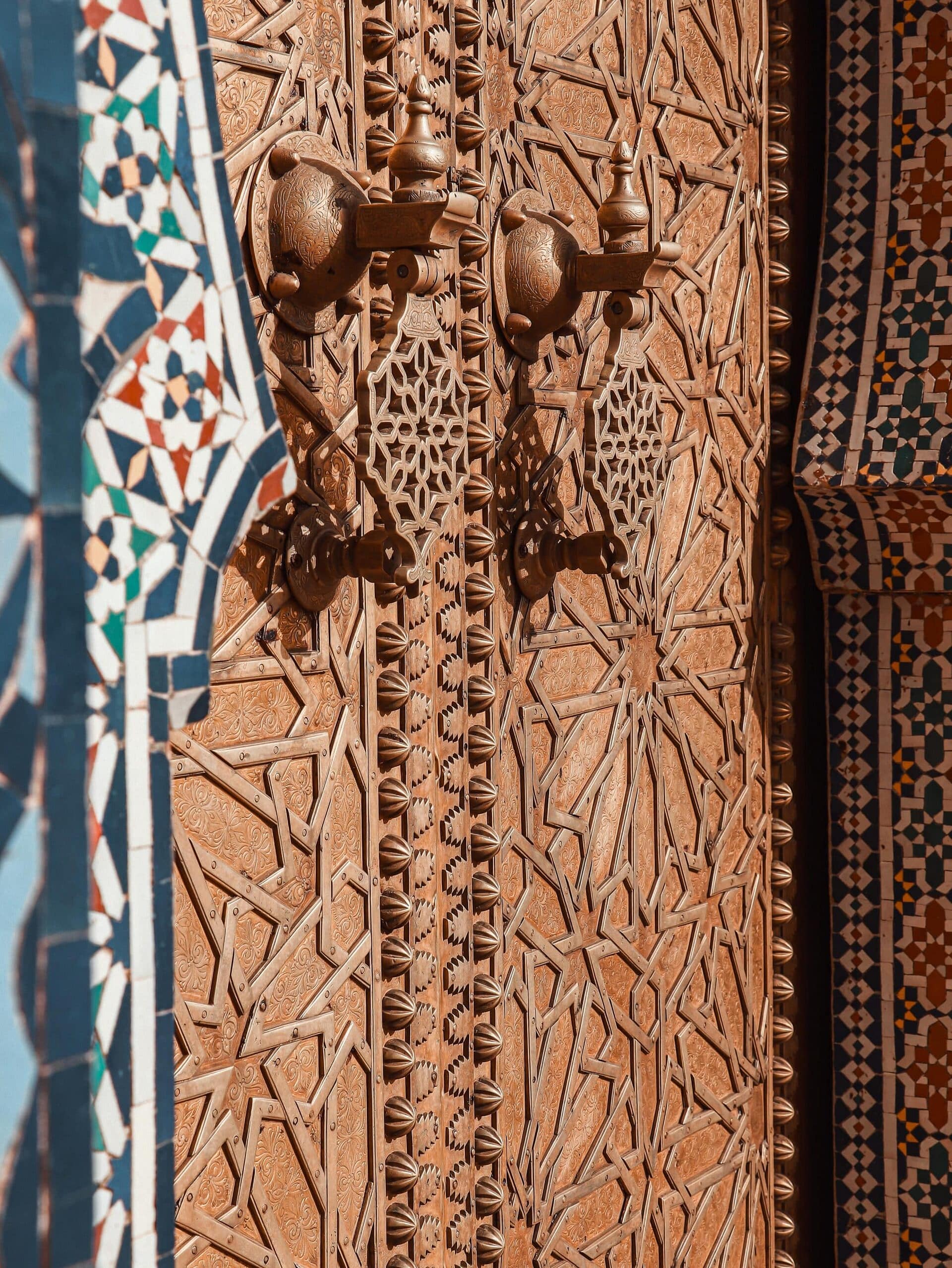 Close-up of a beautifully crafted Moroccan door featuring traditional intricate patterns and copper details.